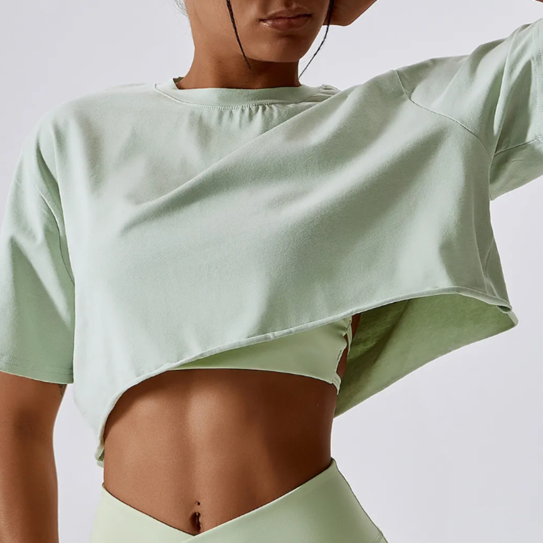 The Cali Cropped Crew Neck Tee, showcasing unparalleled comfort in a blend of cotton and spandex. Experience breathable comfort, quick-dry technology, and durable style effortlessly blended in this versatile tee for any occasion.