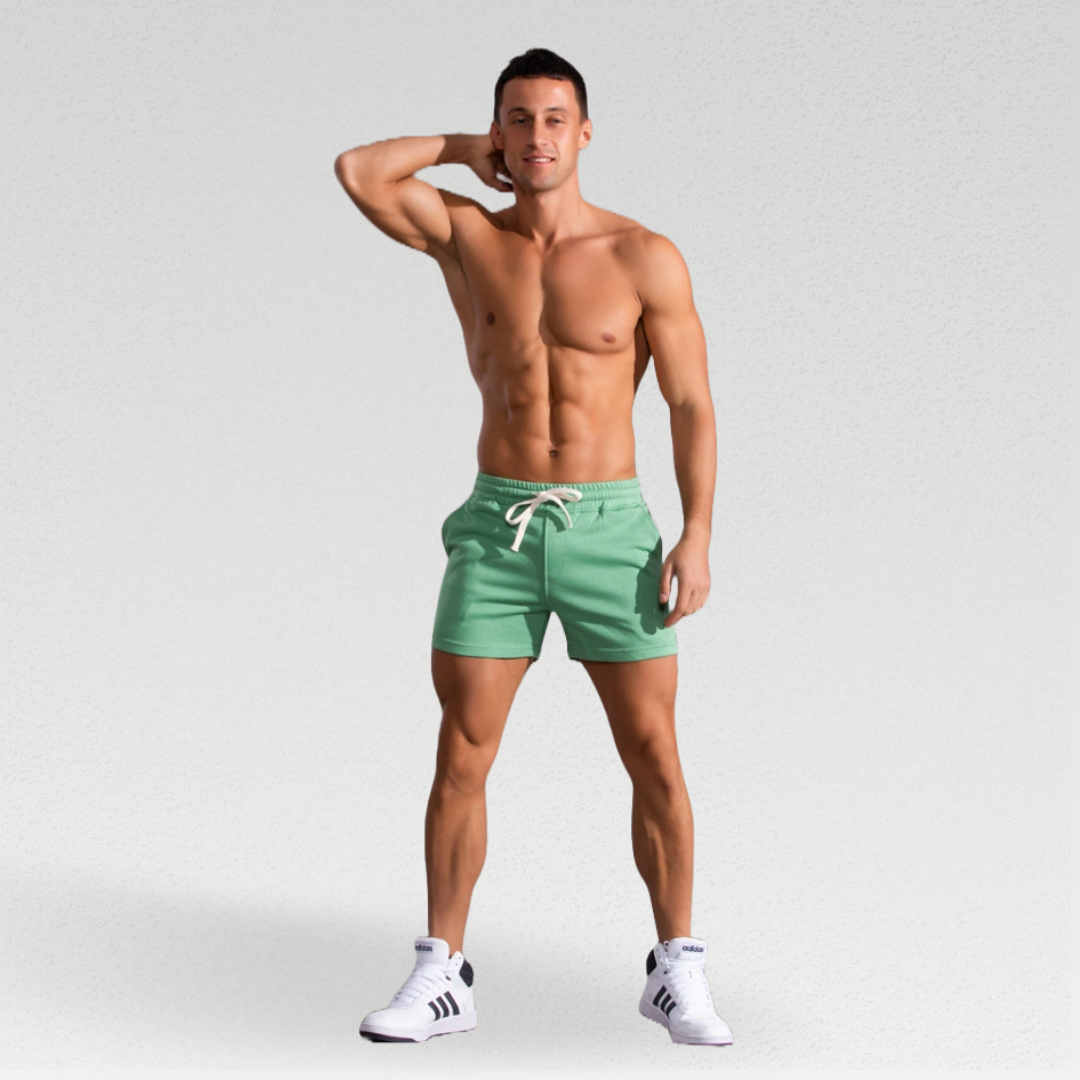 Cambridge Men's Shorts: Premium breathable cotton for cool comfort at home or on the go. Mid-length gym shorts with sweat-wicking material to keep you fresh during workouts or errands. Durable fabric ensures longevity. 3 pockets, drawstring waistband, and sweat-proof design make these shorts perfect for workouts or lounging.