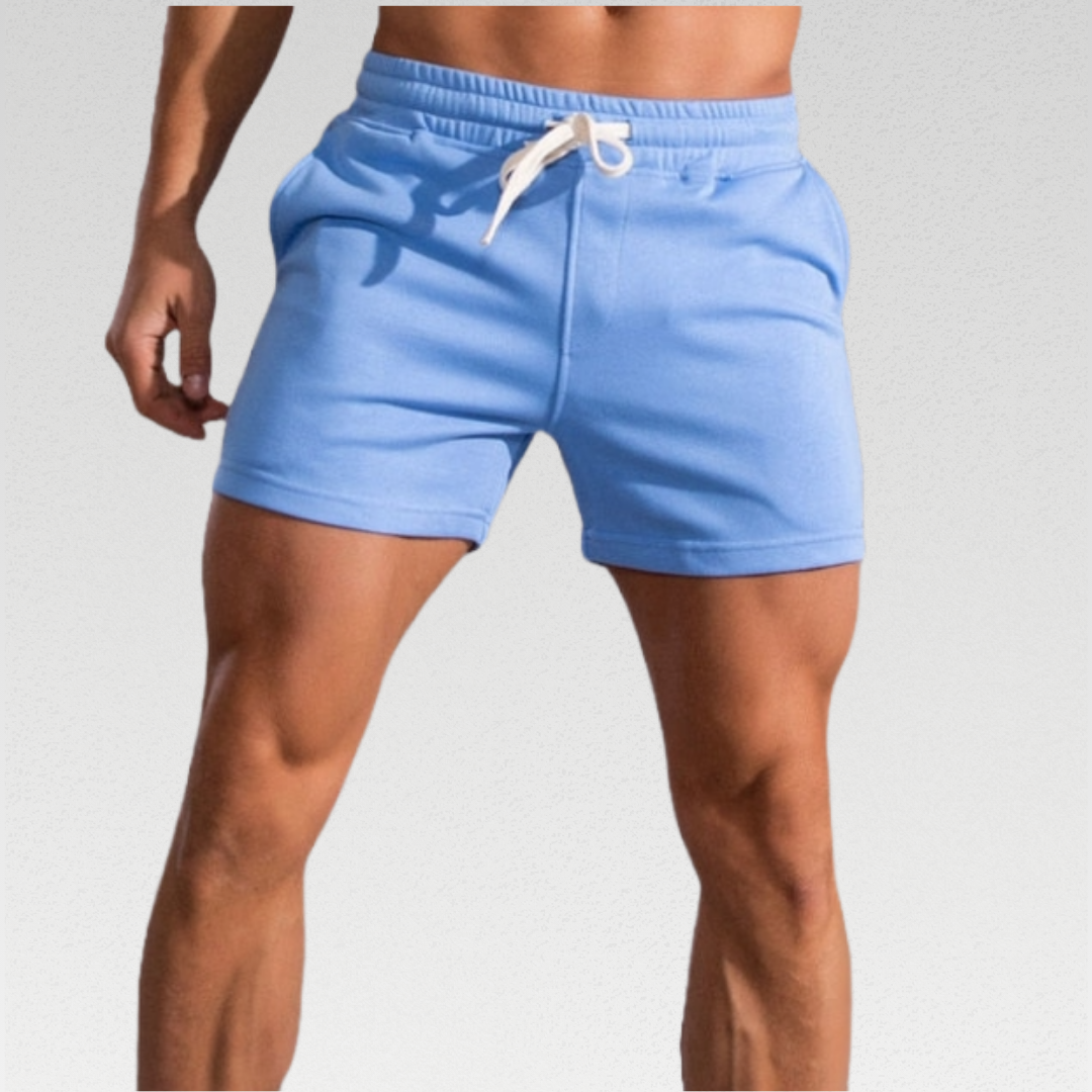 Cambridge Men's Shorts: Premium breathable cotton for cool comfort at home or on the go. Mid-length gym shorts with sweat-wicking material to keep you fresh during workouts or errands. Durable fabric ensures longevity. 3 pockets, drawstring waistband, and sweat-proof design make these shorts perfect for workouts or lounging.