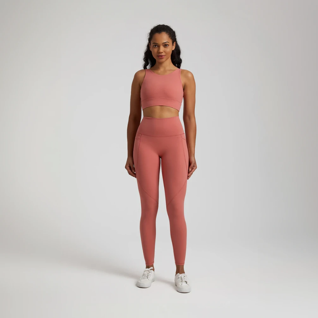 Women's two-piece gym set in breathable nylon/spandex blend. High-waisted leggings with seamless design for a flattering fit. Unique back design on sports bra adds style. Quick-drying material for comfort during workouts. Medium support and compression for unrestricted movement. Venus set - a must-have for any active woman's wardrobe.