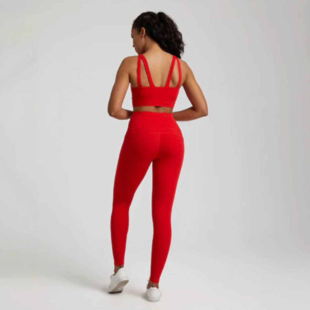 Women's two-piece gym set in breathable nylon/spandex blend. High-waisted leggings with seamless design for a flattering fit. Unique back design on sports bra adds style. Quick-drying material for comfort during workouts. Medium support and compression for unrestricted movement. Venus set - a must-have for any active woman's wardrobe.