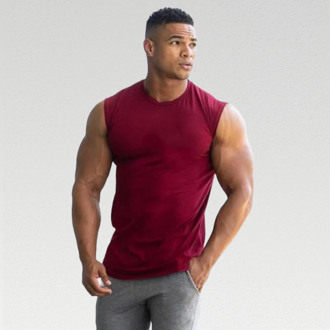 Upgrade your gym wardrobe with our Hero Sleeveless Tee, a premium blend of high-quality broadcloth and cotton for a comfortable fit. This versatile and stylish shirt is perfect for various activities, providing maximum comfort and durability during your workouts. Feel confident and look great whether you're hitting the gym, running errands, or relaxing at home.