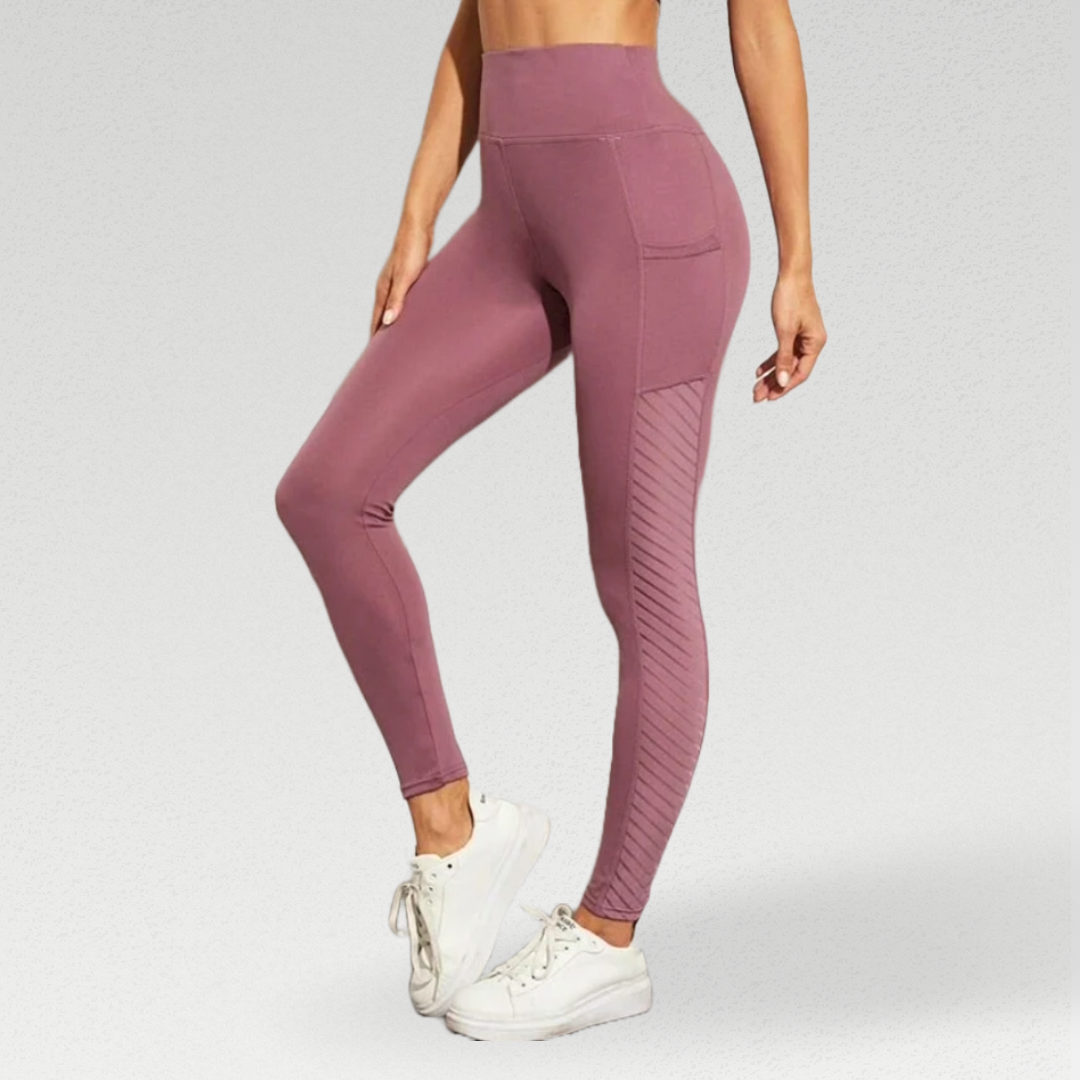 Enhance your workout experience with our Ribbon Leggings, meticulously crafted for comfort and style. The silky soft poly/broadcloth/spandex blend moves with you, providing flexibility and durability. The leggings feature beautiful side panel detailing for a luxurious touch. Stay comfortable with breathable fabric and enjoy the added support of a high waisted compression waistband. Mesh panels add ventilation and style, while pockets keep your essentials handy. 