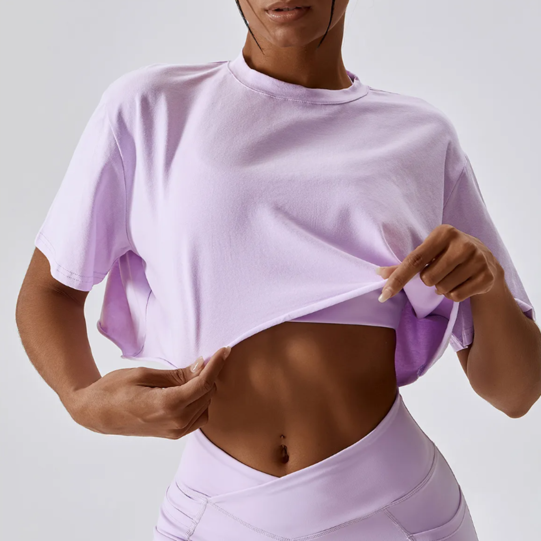 The Cali Cropped Crew Neck Tee, showcasing unparalleled comfort in a blend of cotton and spandex. Experience breathable comfort, quick-dry technology, and durable style effortlessly blended in this versatile tee for any occasion.